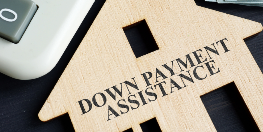 Down payment assistance written on a model of home